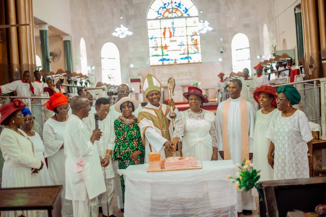Cutting the celebration cake inside the cathedral